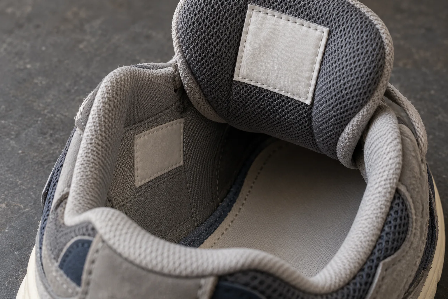 Illustrative sneaker interior with an unlettered tongue label, lining, and insole edge
